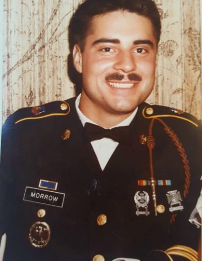 A man in military uniform with mustache and bow tie.