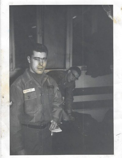 A man in uniform standing next to another man.