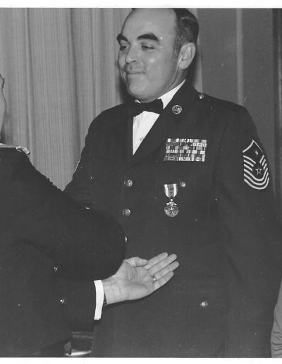 A man in uniform shaking hands with another person.