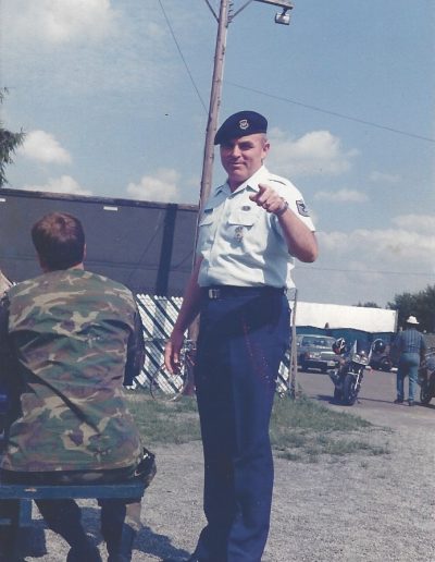 A man in uniform standing next to another person.